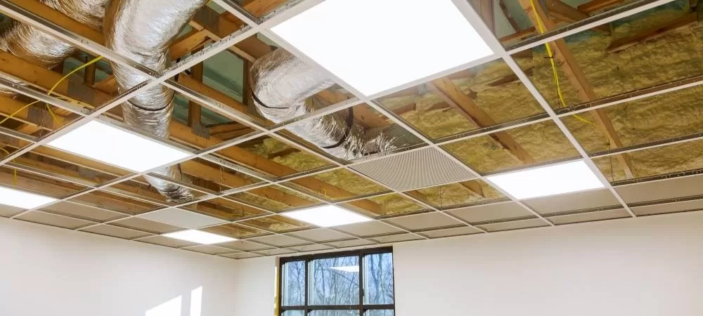 Flexible Industrial Air Conditioning Ducts in a roof are shown. A window on a white wall is shown in the background.